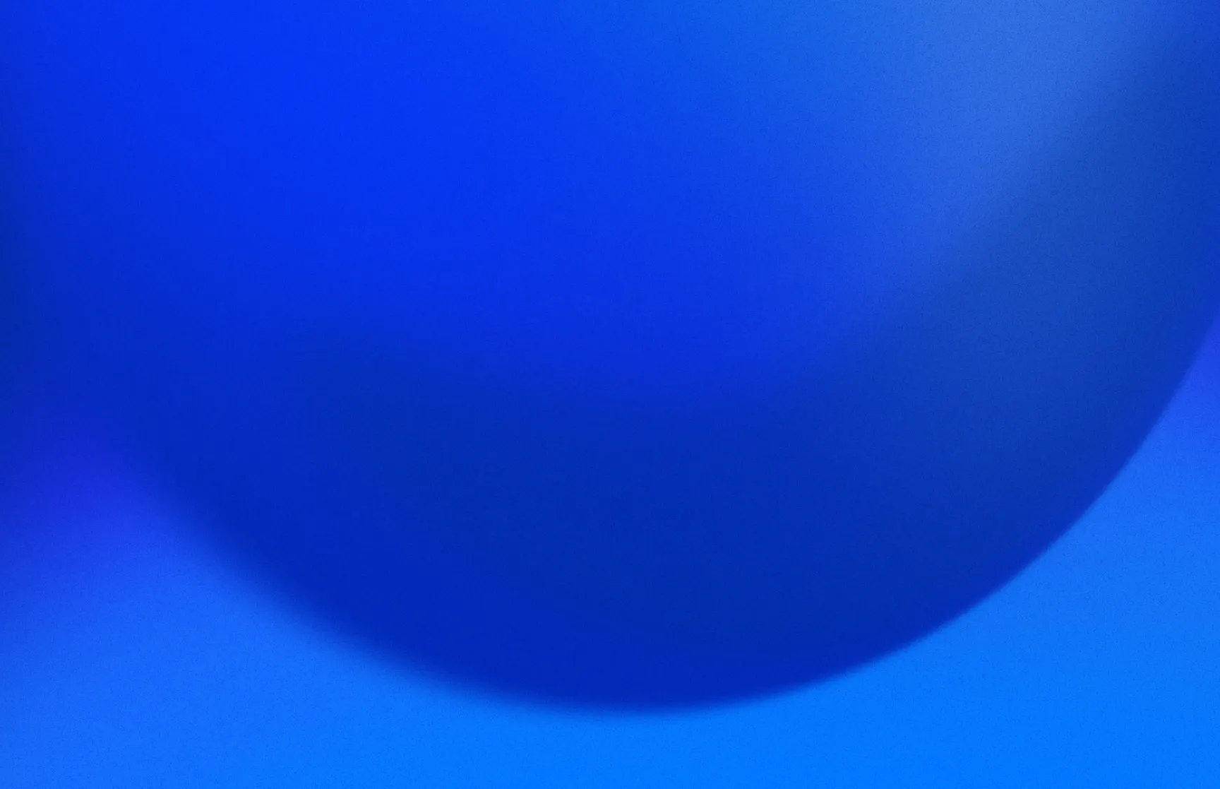 Close-up of a large blue spherical object with a smooth surface and gradient shading.