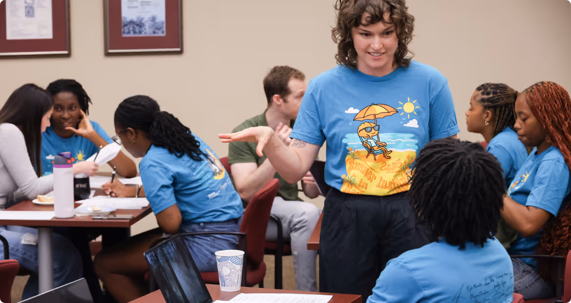 Diverse group of students engaged in hands-on neuroscience training workshop with instructor