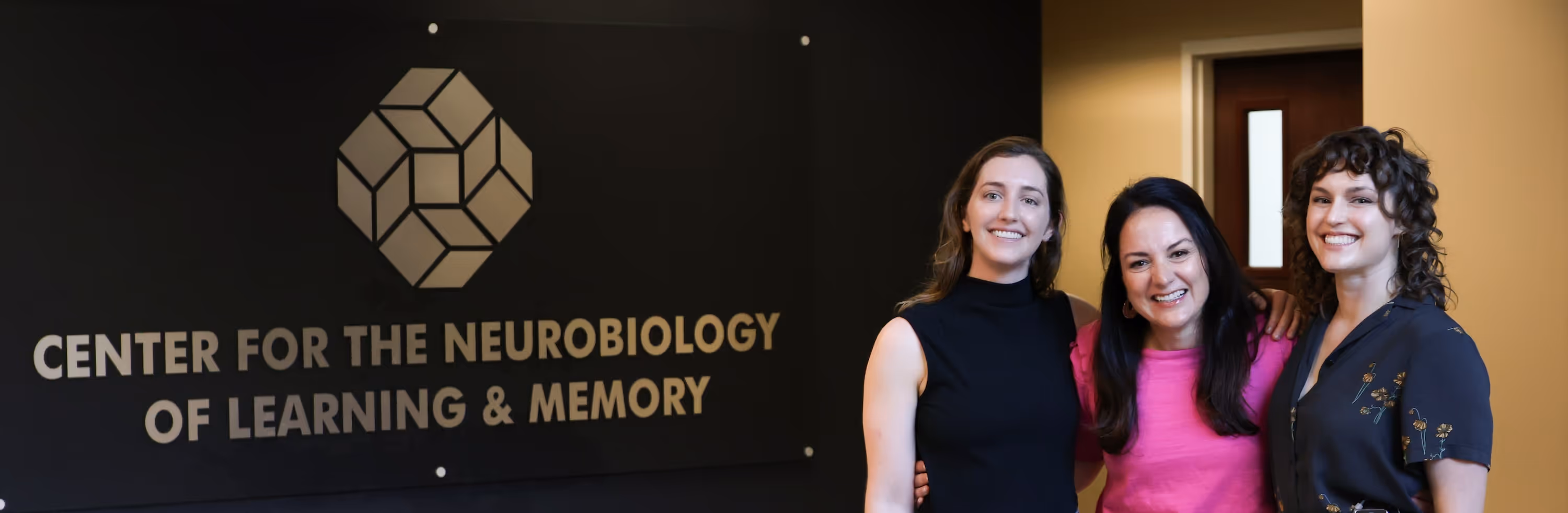 Three NeuroEngage Lab team members smiling at UC Irvine Center for the Neurobiology of Learning and Memory