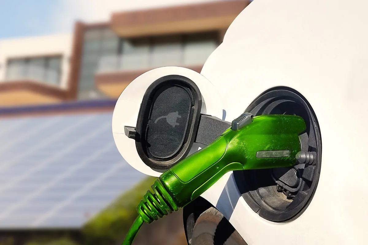 EV charger plugged into a car at a Sydney home with rooftop solar, showing higher loads that need a compliant switchboard
