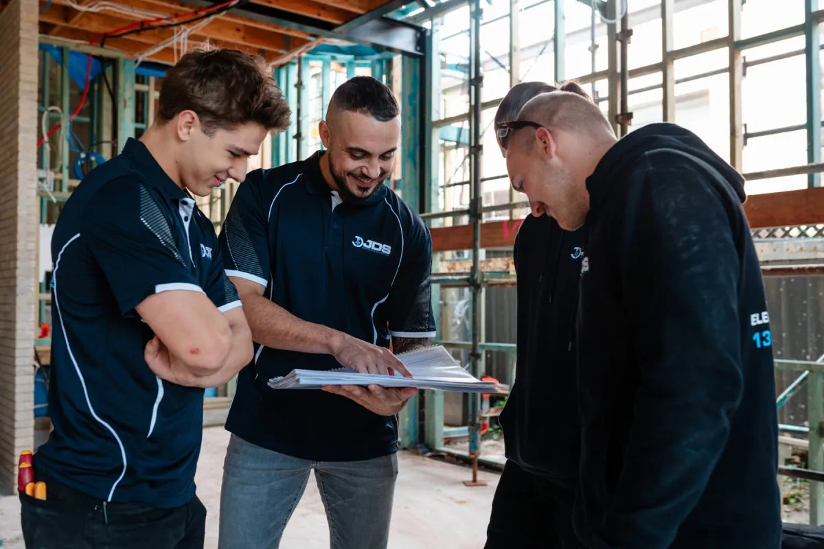 Licensed JDS electricians conducting an on-site switchboard inspection and scope check in Sydney
