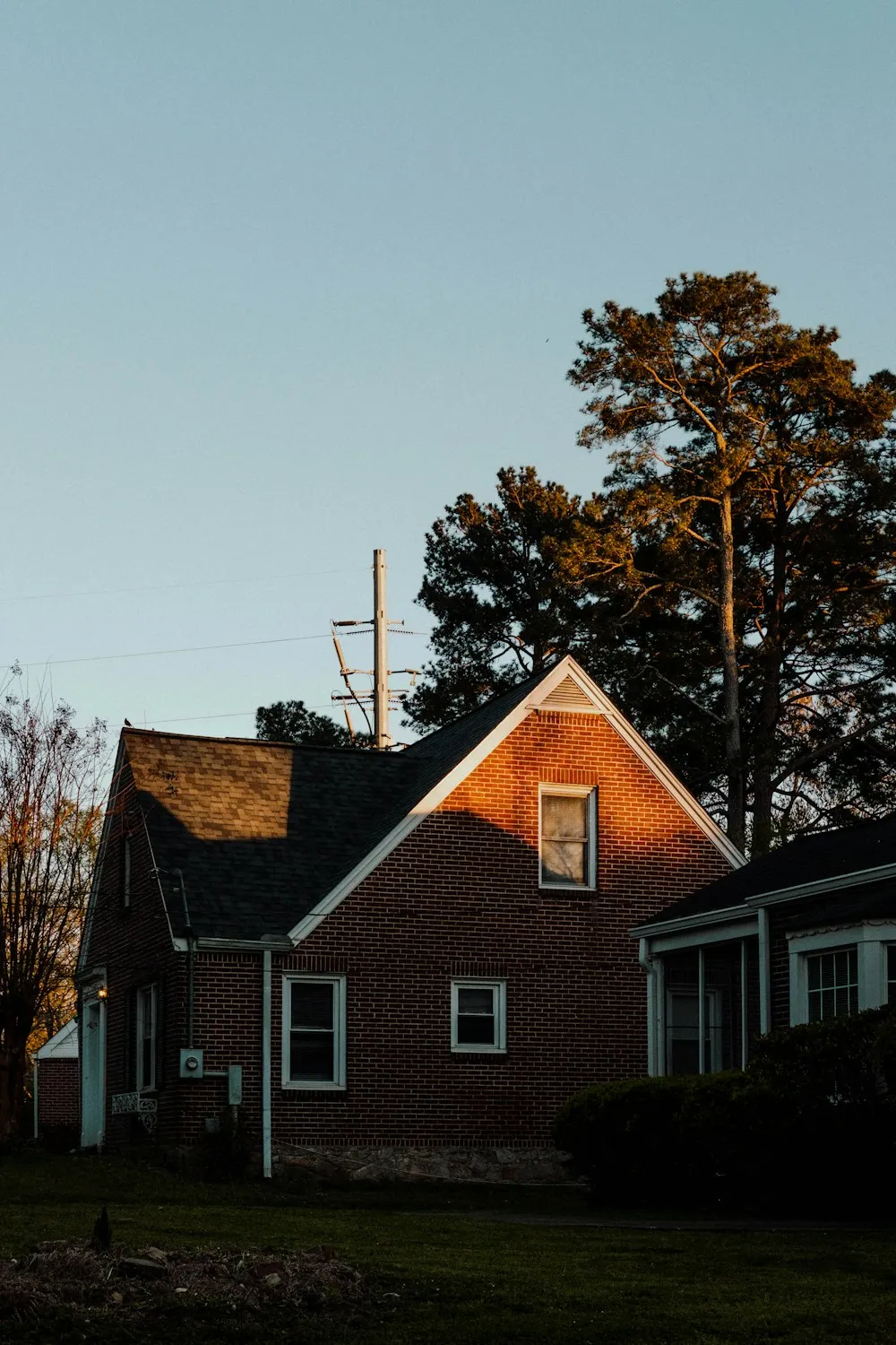 Brick house with evening sunlight on the wall.