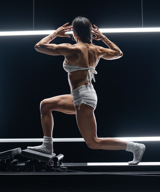 Deep lunge on the Megaformer in a Leg Focus class