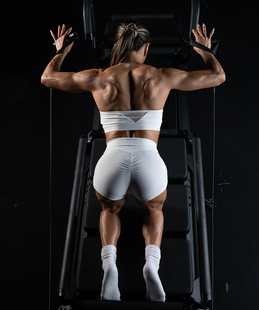 Standing pose on the Megaformer during a Lagree Heat class