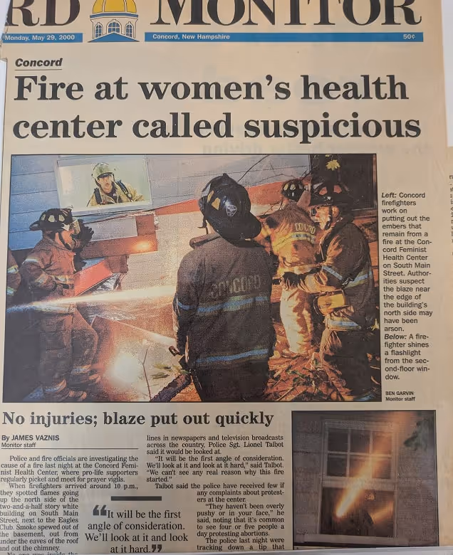 Newspaper front page with headline about suspicious fire at women's health center; photo shows firefighters extinguishing flames inside a building.
