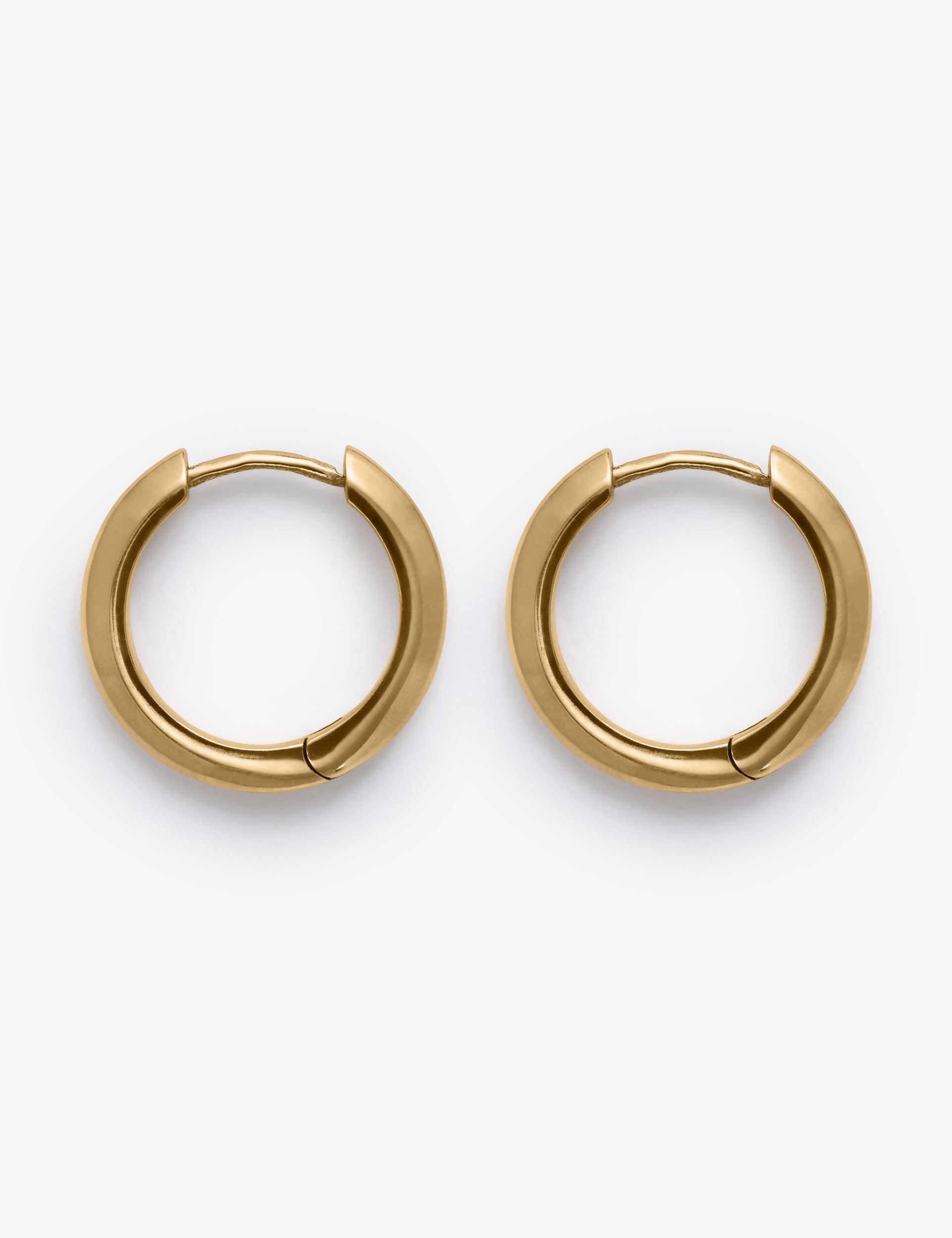 Gold stain hoop earrings on a white background.