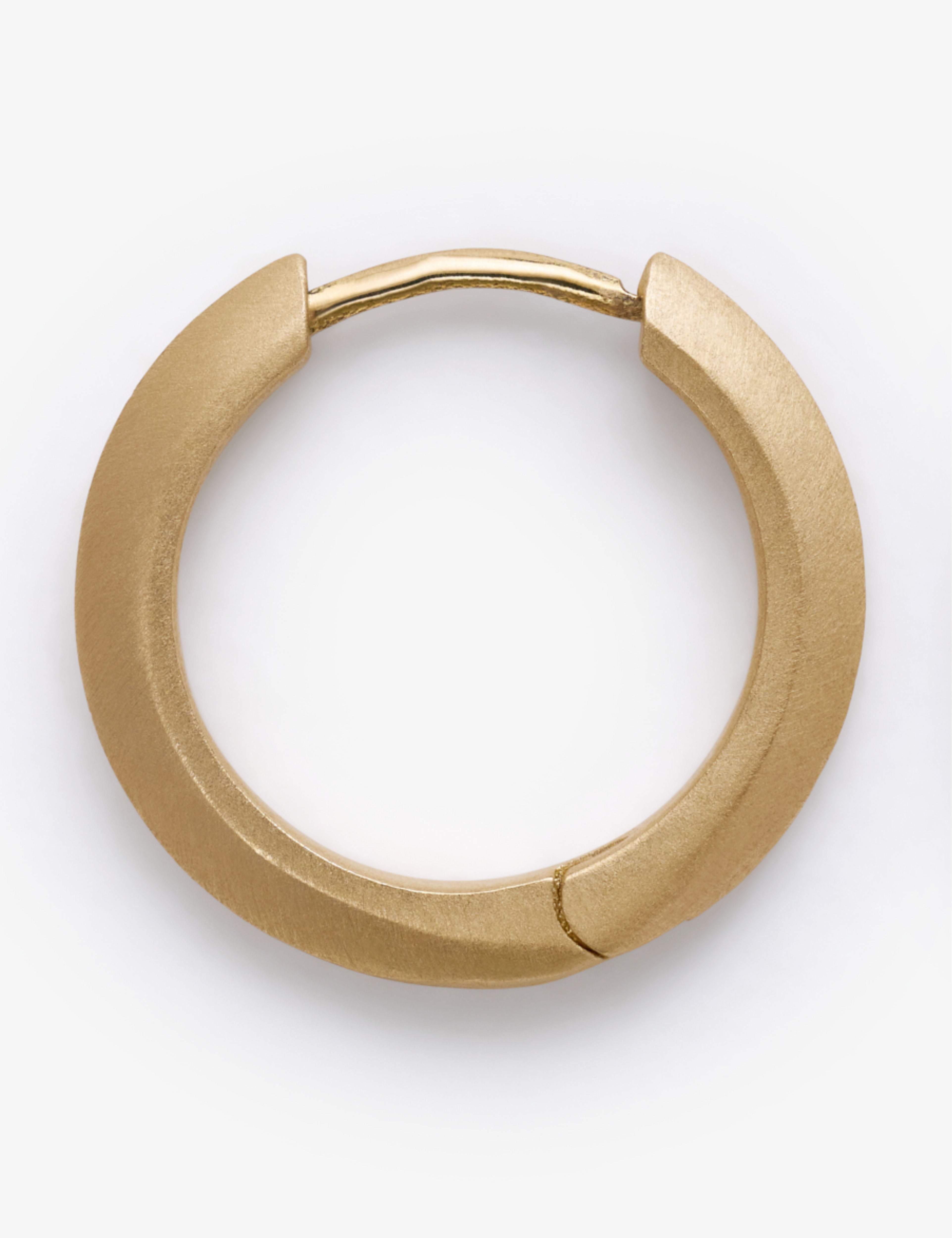 Gold hoop earring on a white background.