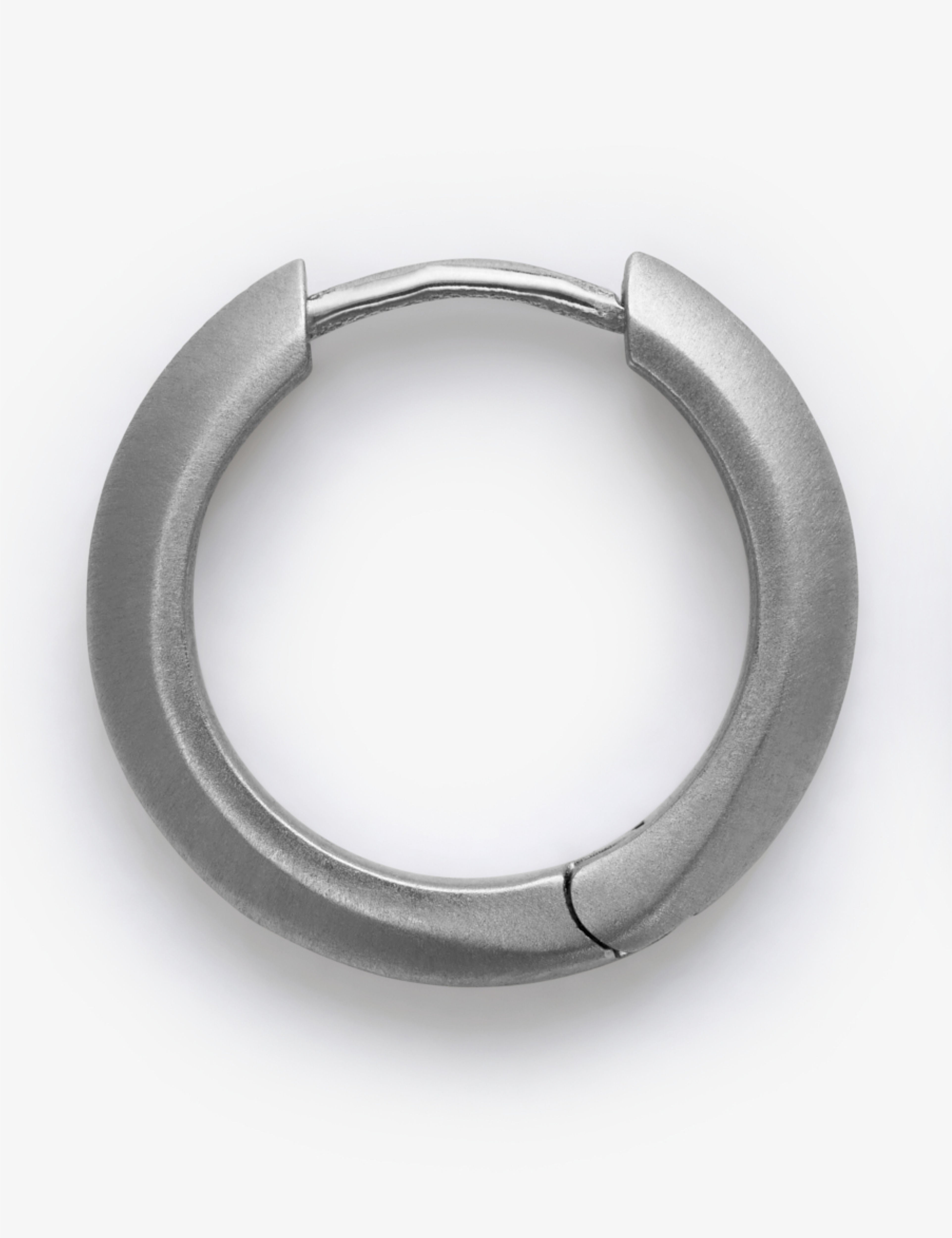 Silver hoop earring on a white background.