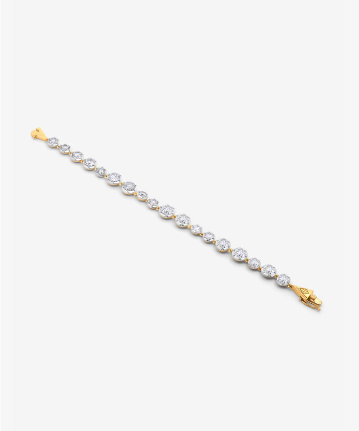 Full view of gold diamond tennis bracelet laid flat on a white background showing its geometric clasp.