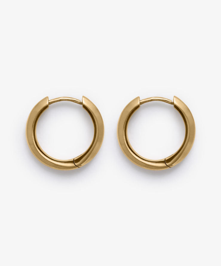 Gold stain hoop earrings on a white background.