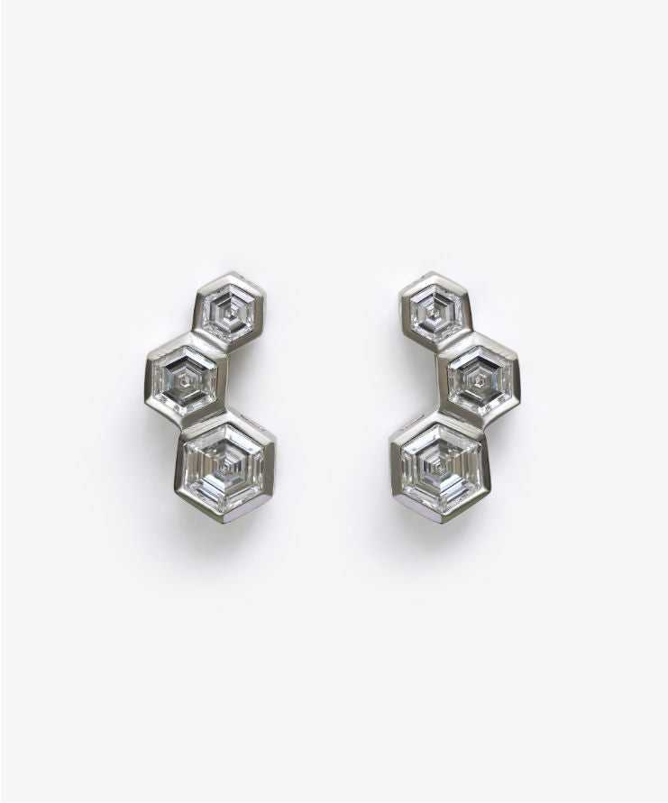 Hexagon diamond stud earrings shown on white background for product display.