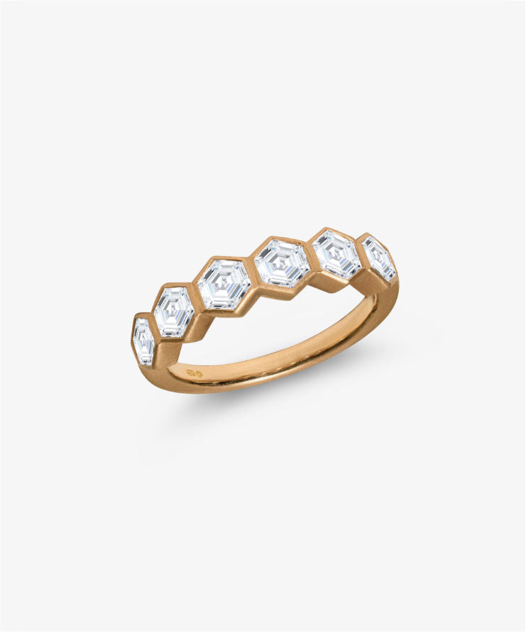 18k gold hexagon diamond eternity ring displayed on a white background.