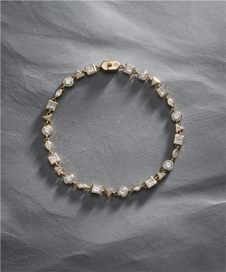 Three diamond tennis bracelets in white, rose, and yellow gold displayed on grey background.