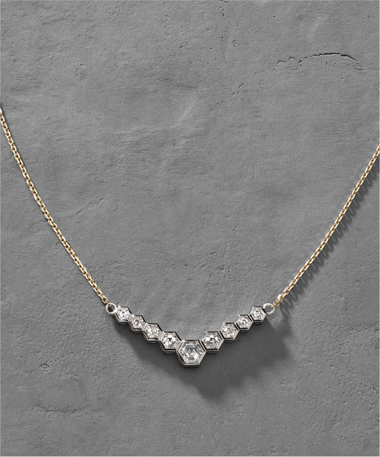 Model wearing hex diamond necklace.