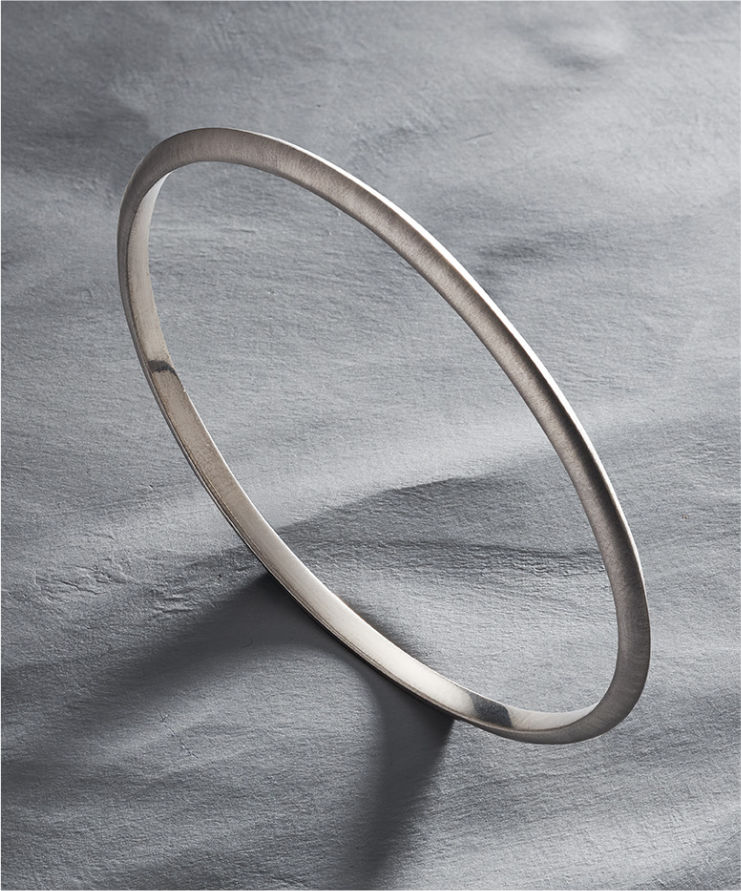 Close-up of a person wearing a brown garment with a belt and cuff detail.