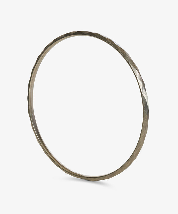 Gold bangle on a white background.