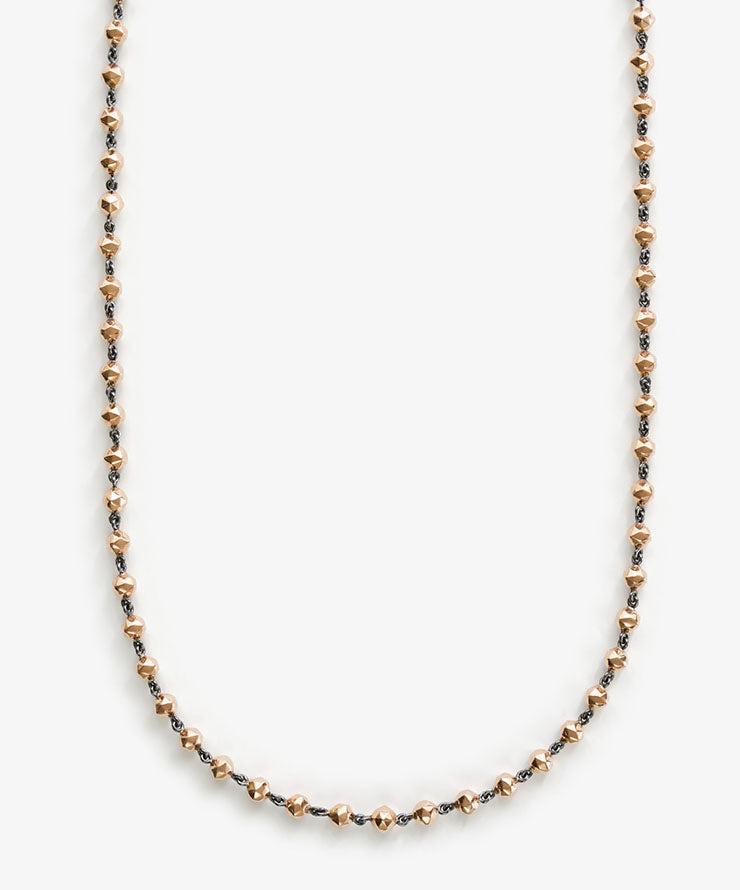 Rose gold necklace on a white background.