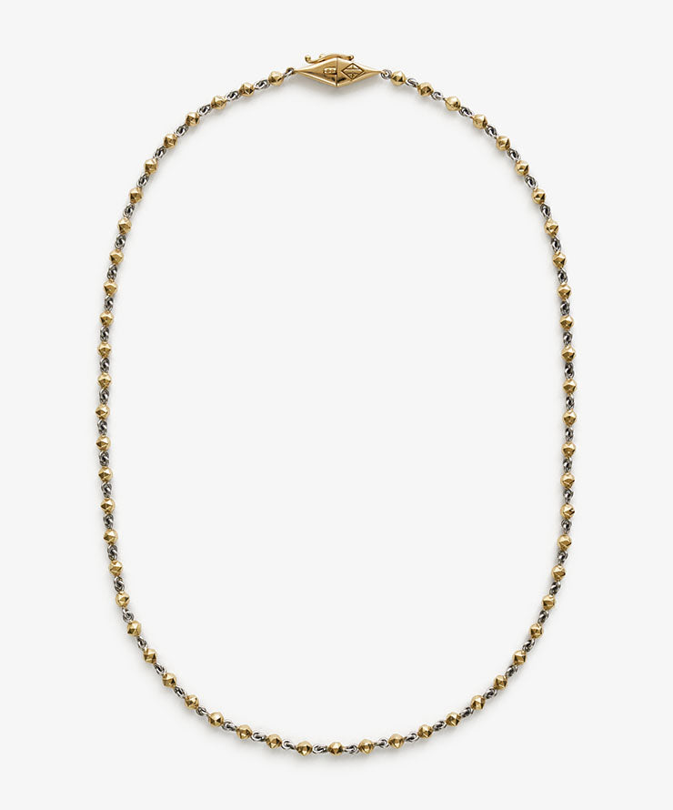 Necklace with gold and silver beads on a white background.