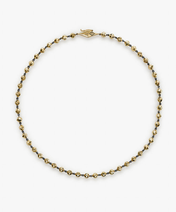 Necklace with gold and silver beads on a white background.