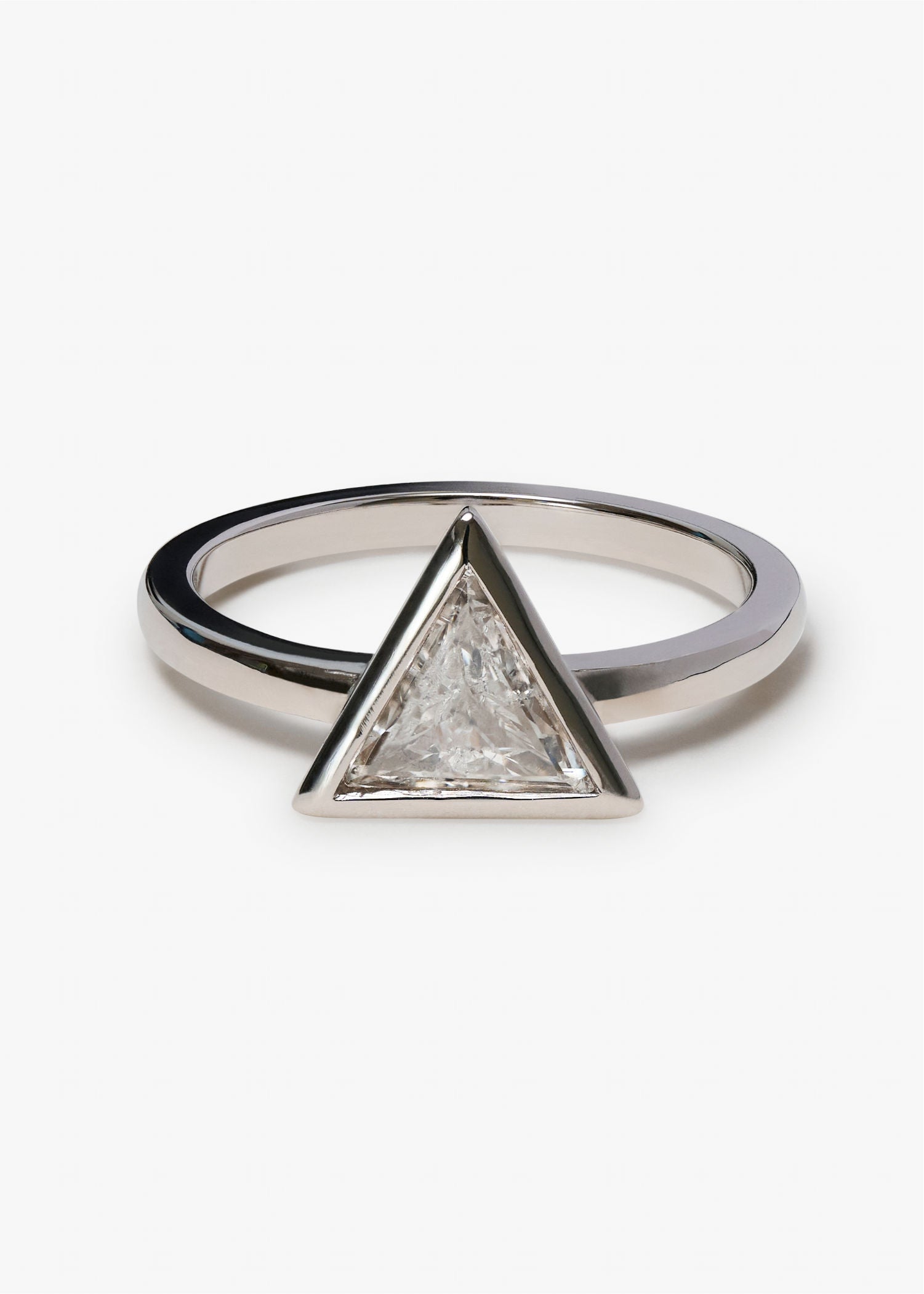 White gold ring with single triangular diamond in minimalist bezel setting.