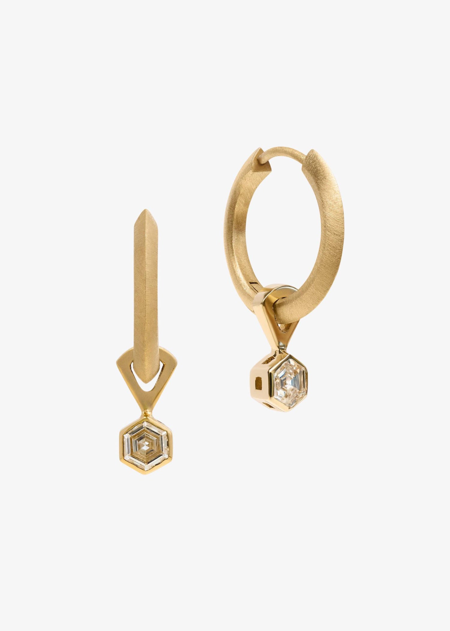 Yellow gold earrings with hexagon-cut diamonds in geometric drop design on white background.
