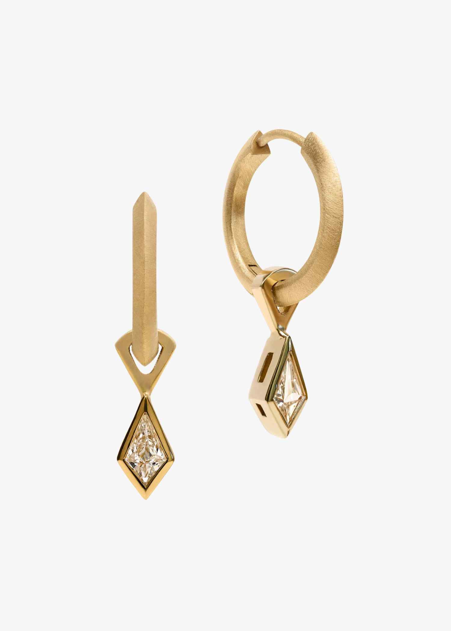 Yellow gold earrings with kite-cut diamonds in geometric drop design on white background.
