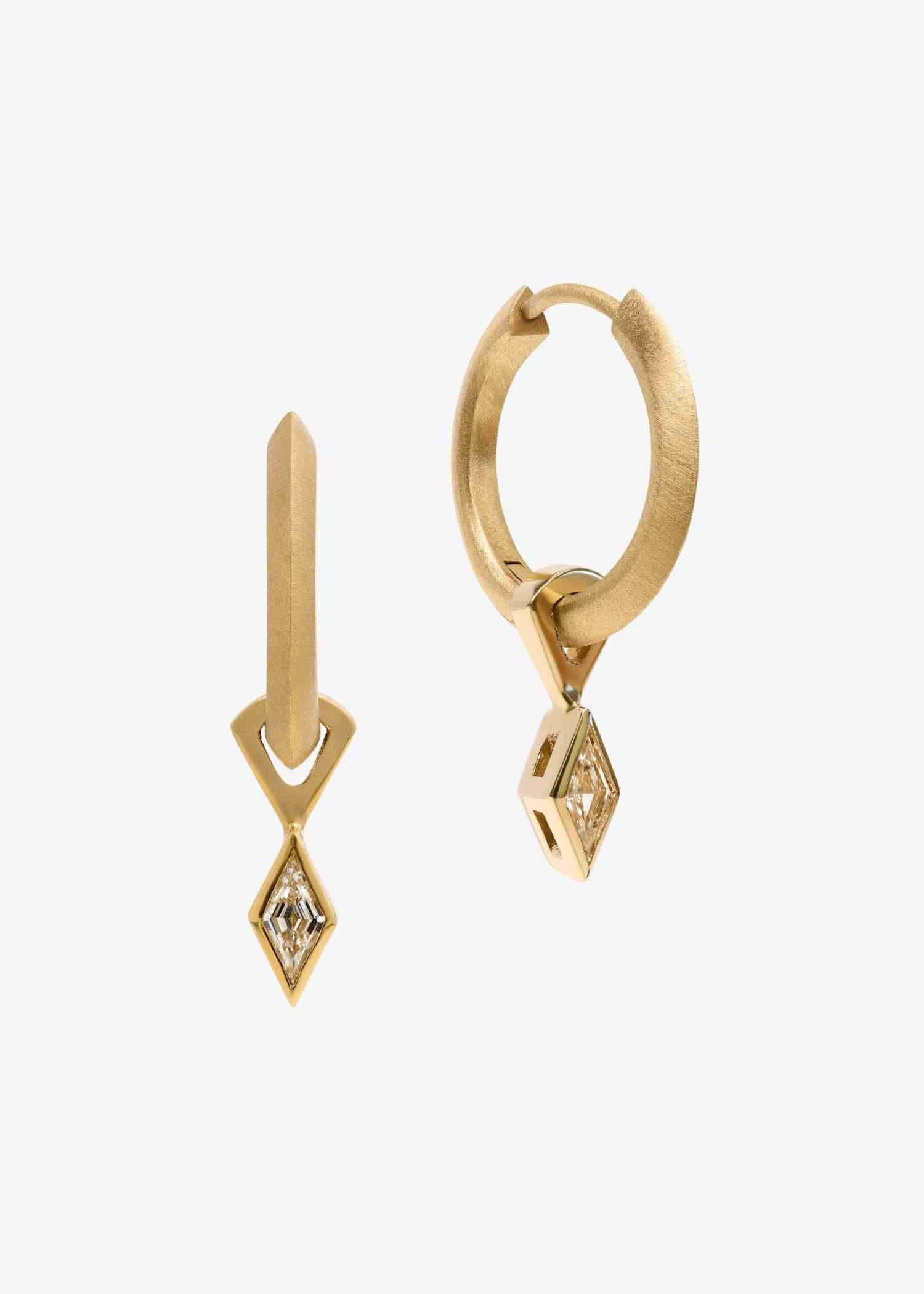 Yellow gold hoop earrings featuring lozenge-cut diamonds on grey textured background.
