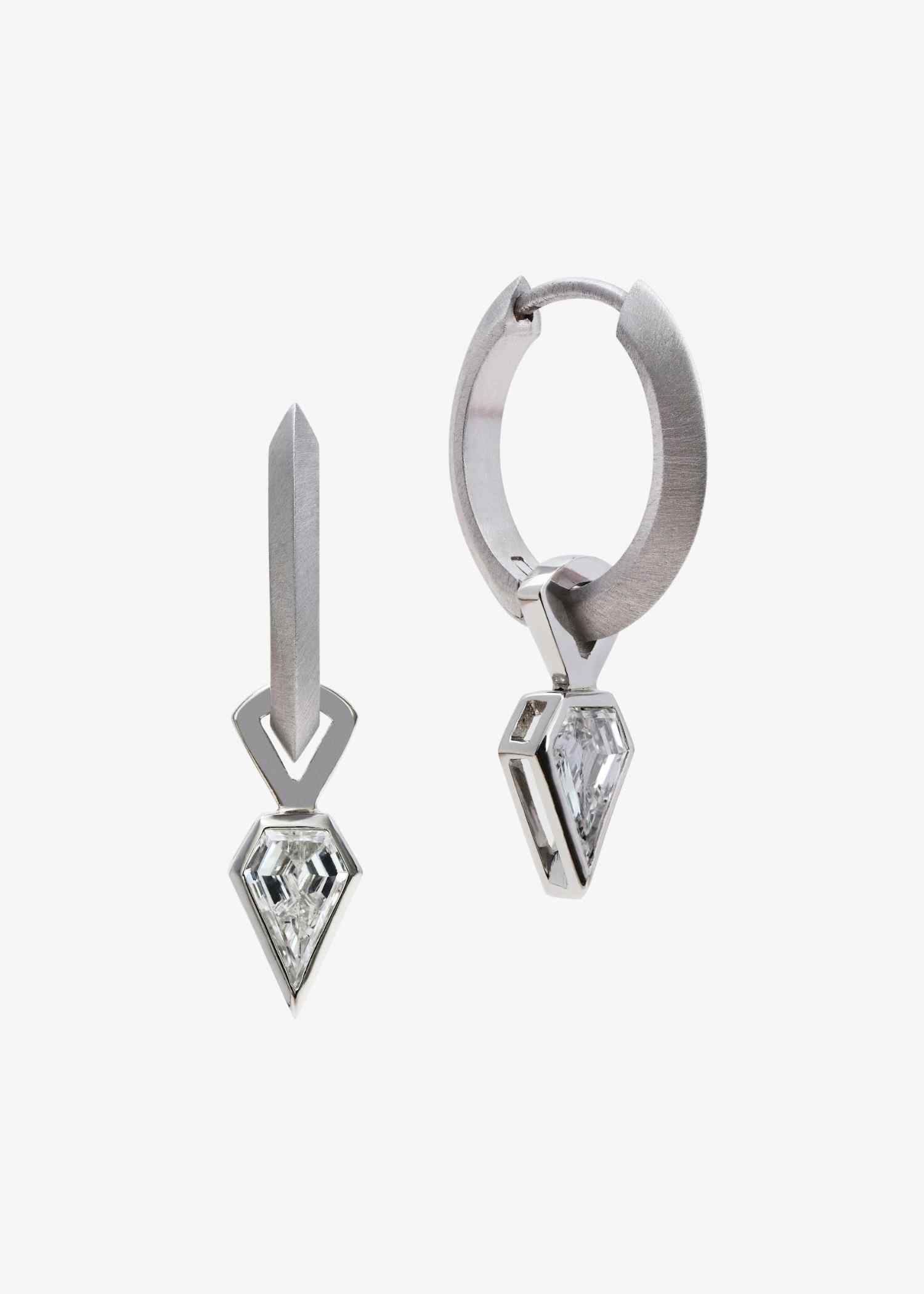 Platinum hoop earrings featuring shield-cut diamonds on grey textured background.