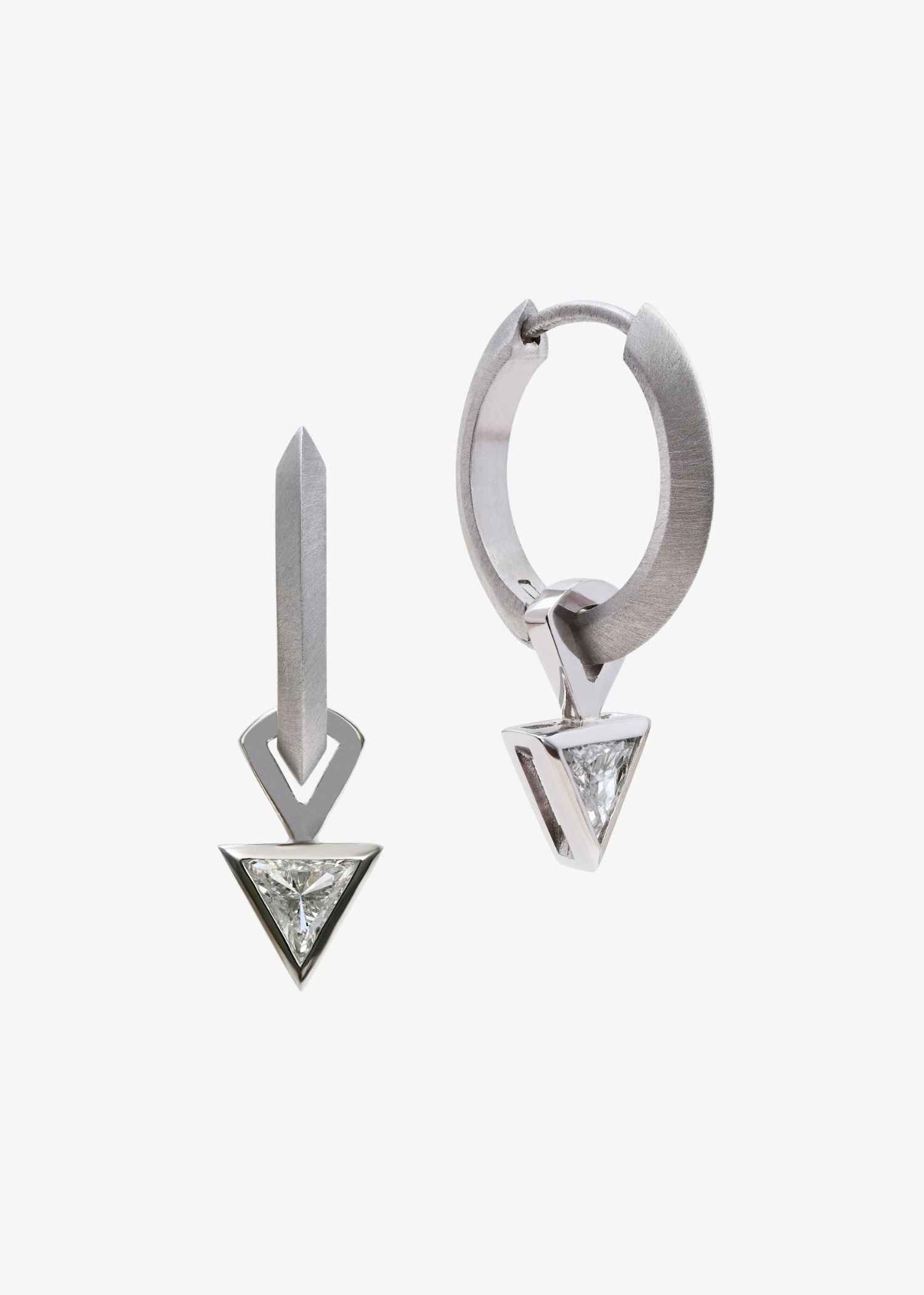 Platinum hoop earrings featuring triangular-cut diamonds on grey textured background.