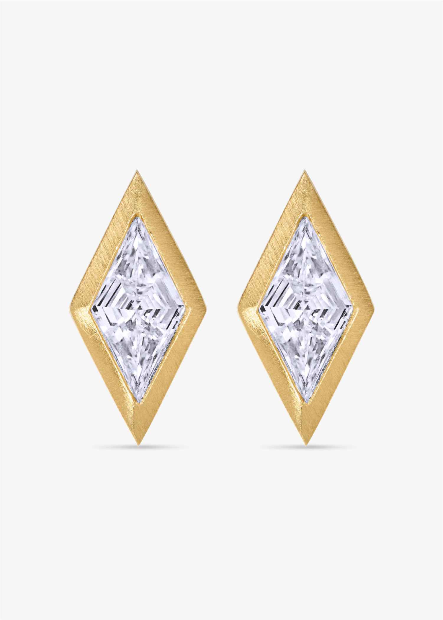 Gold earrings with clear gemstones on a white background.