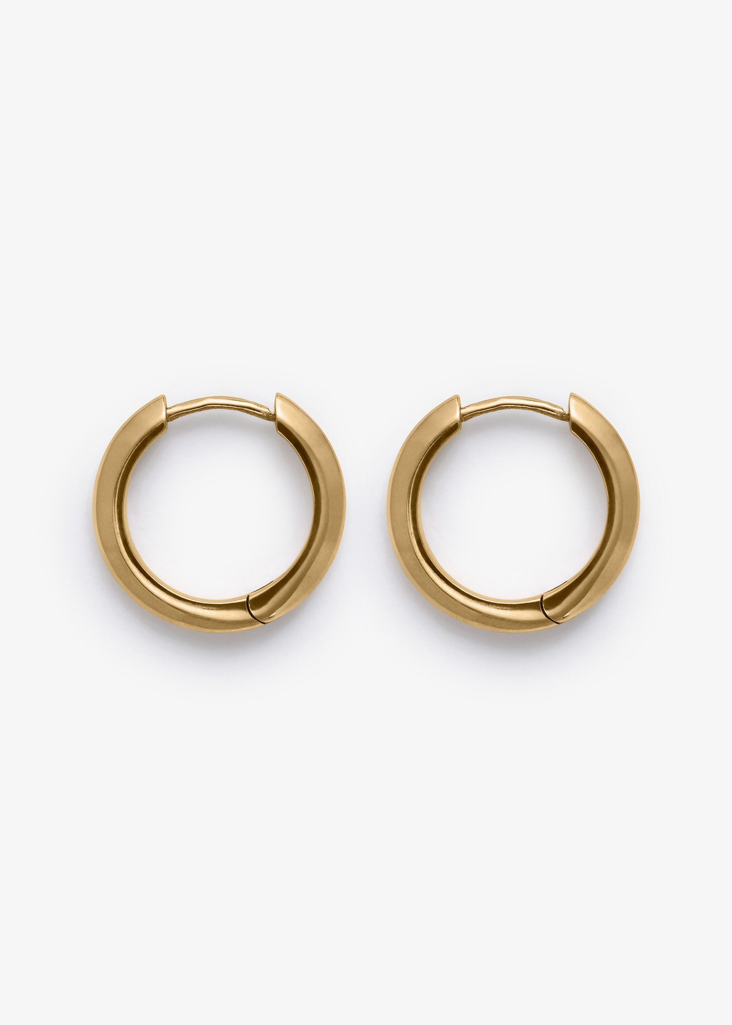 Gold stain hoop earrings on a white background.