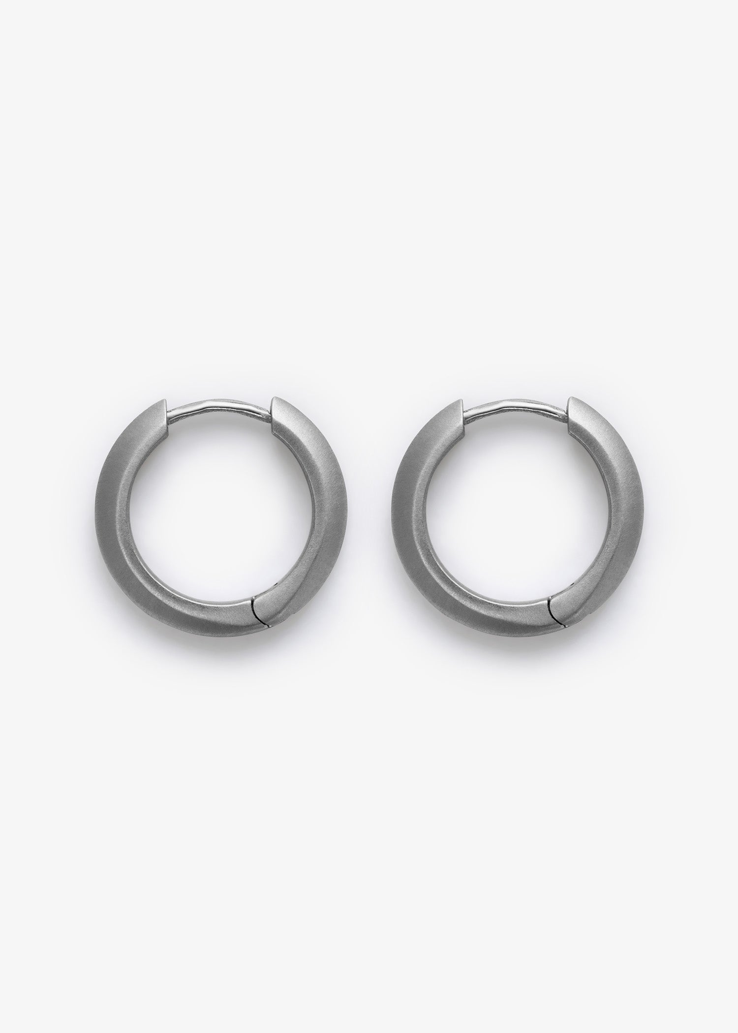 Pair of silver platinum earrings on a white background.