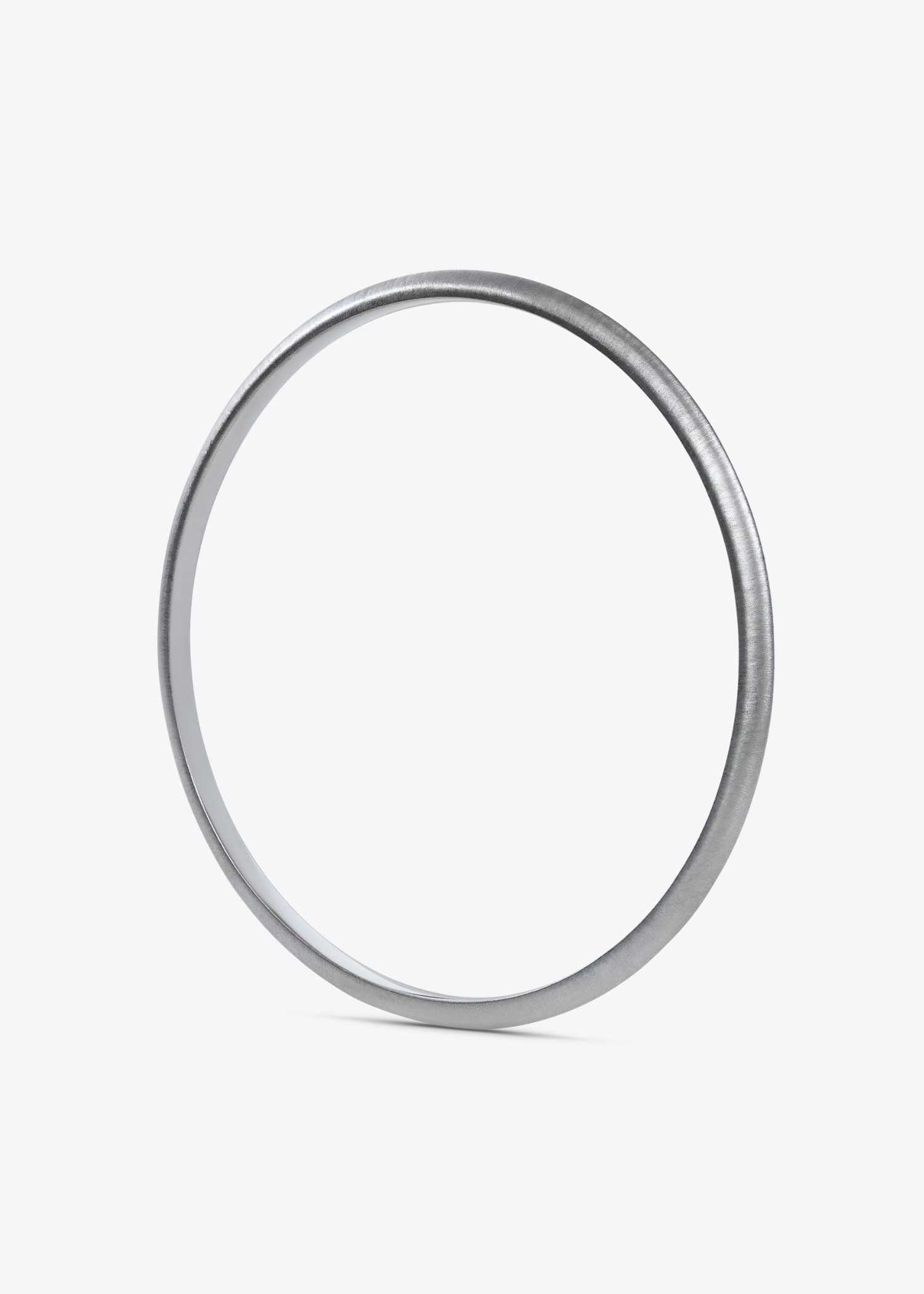 White gold bracelet on a textured gray surface.