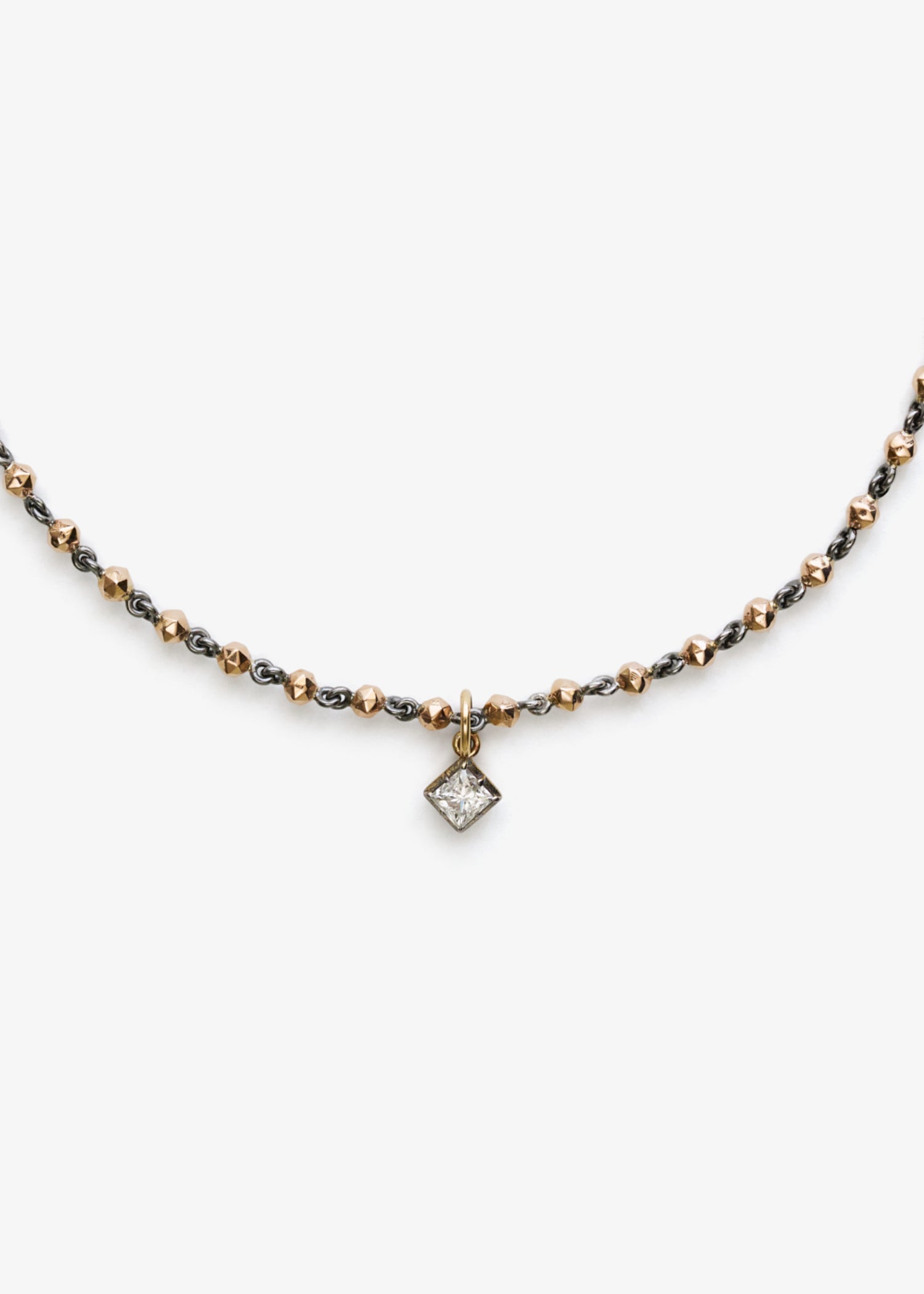 18k rose gold bead necklace with faceted round links and a geometric clasp, displayed on a white background.