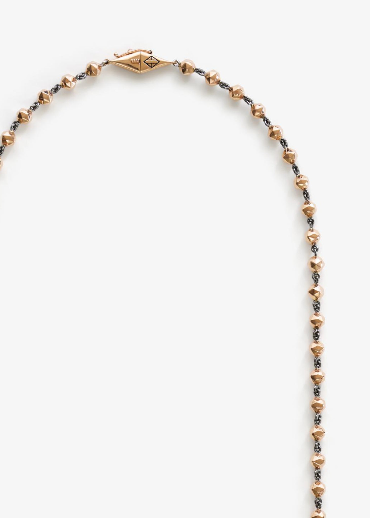 Model wearing white gold facet bead necklace.