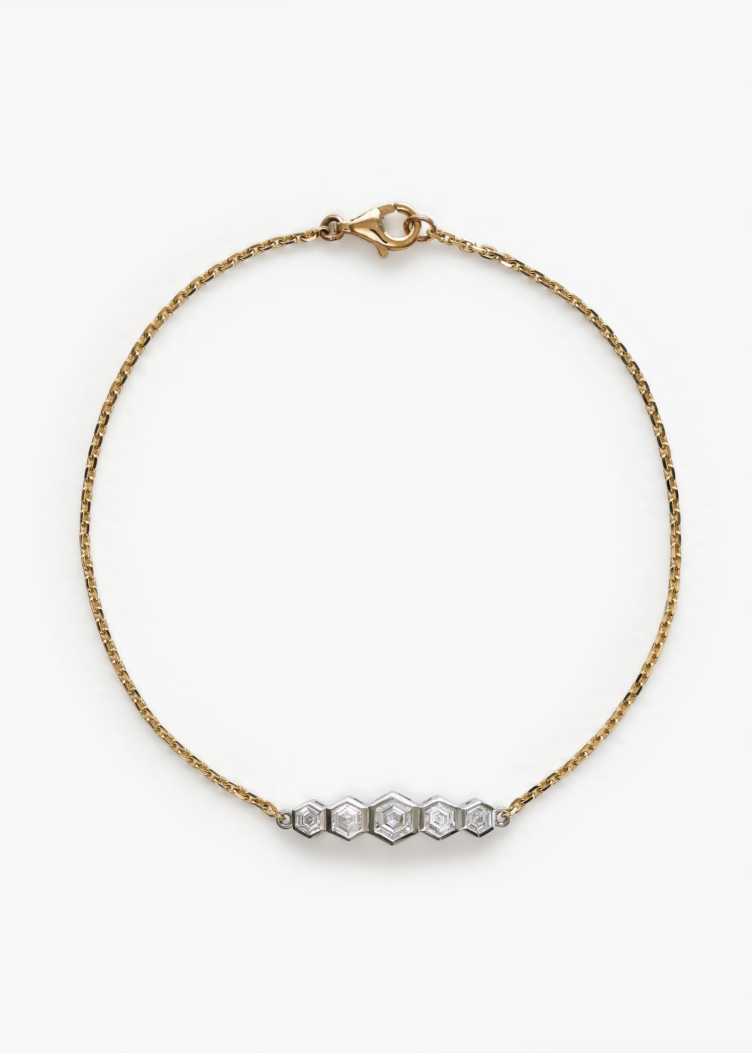 Yellow gold bracelet with five hexagonal diamond settings on white background.