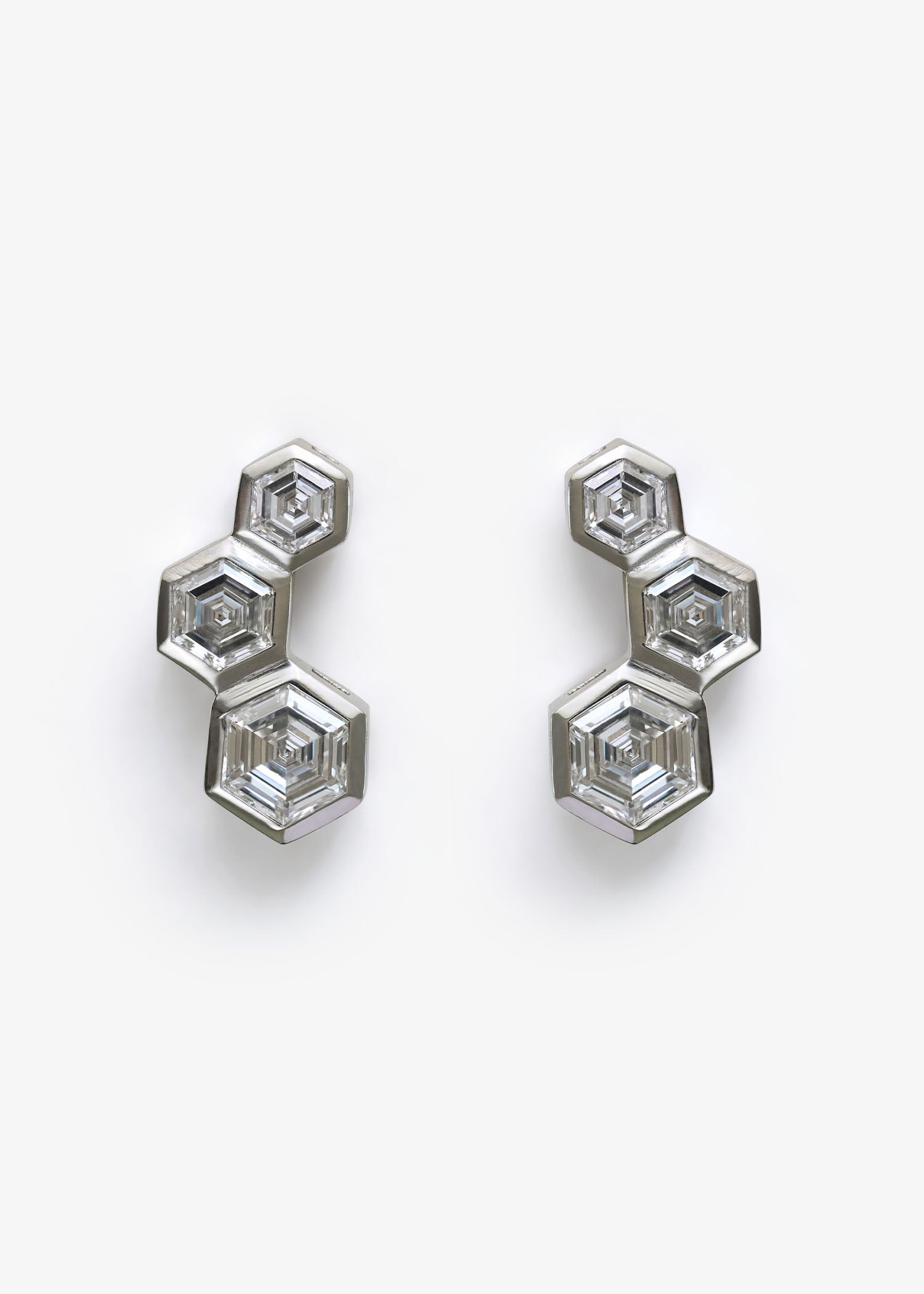 Hexagon diamond stud earrings shown on white background for product display.