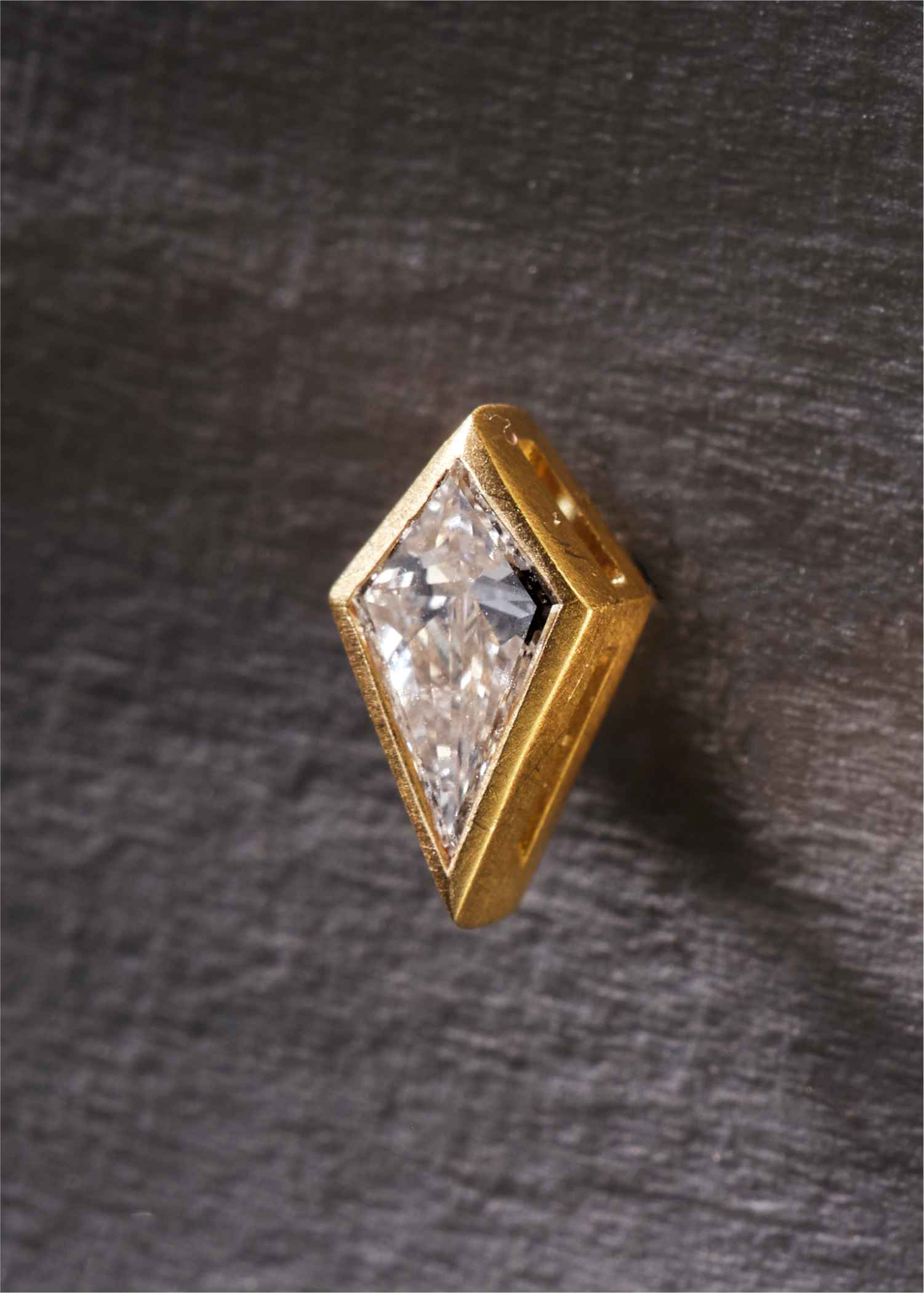 Gold stud earrings with clear gemstones on a white background.