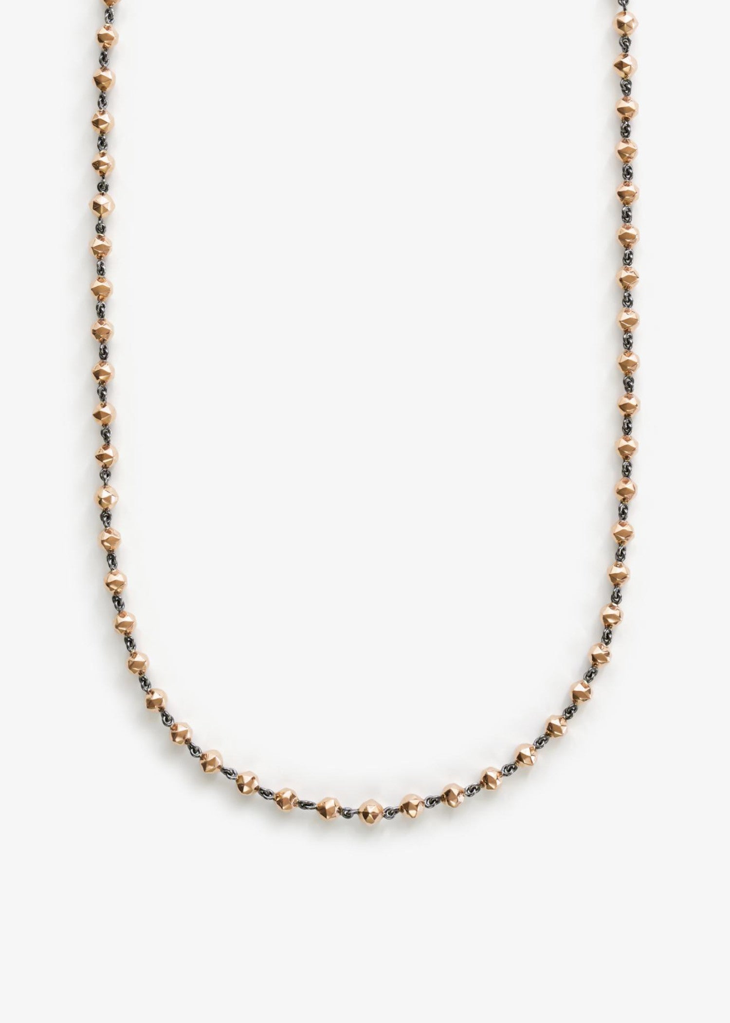 Rose gold necklace on a white background.