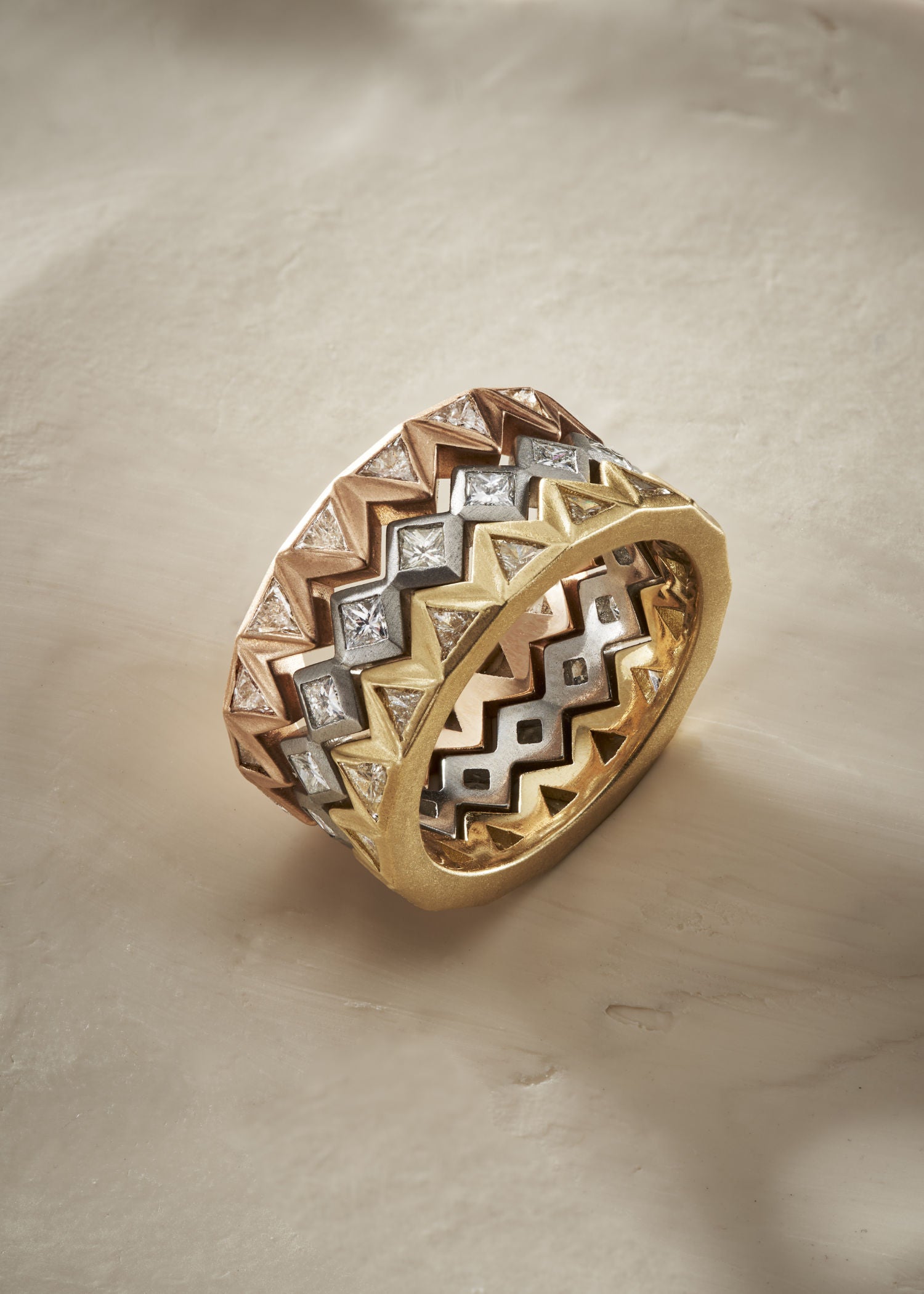 Gold ring with diamond accents on a white background.