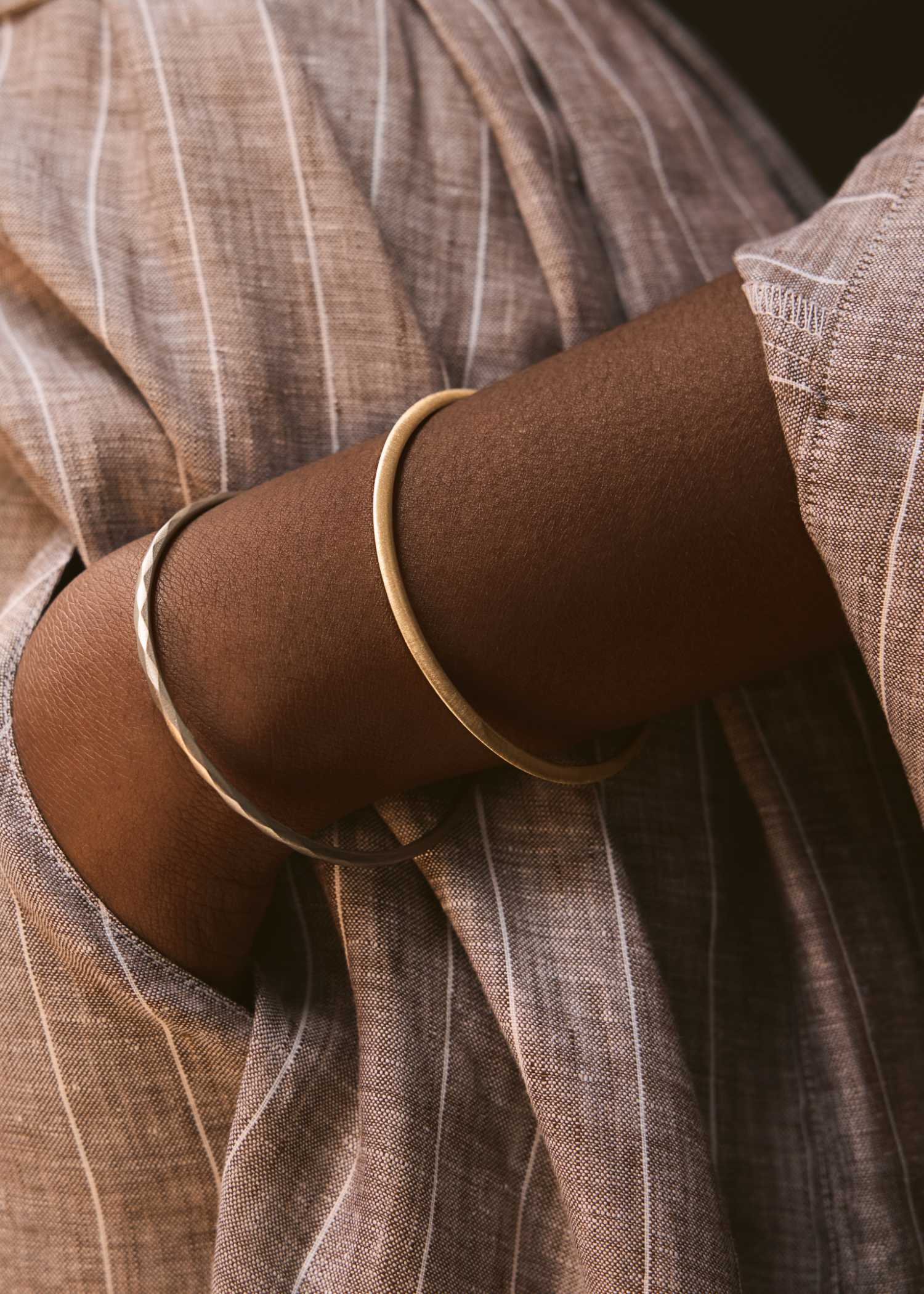 White gold bracelet on a textured gray surface.
