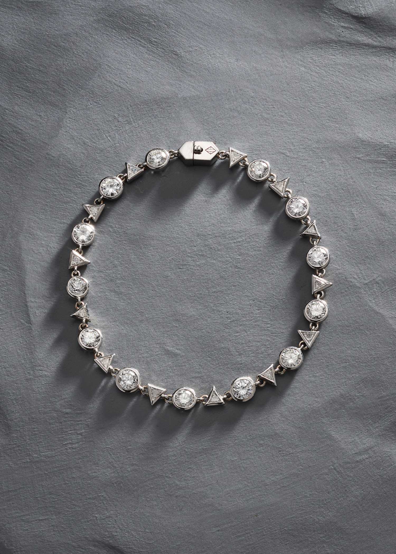 Platinum diamond tennis bracelet displayed on white background.