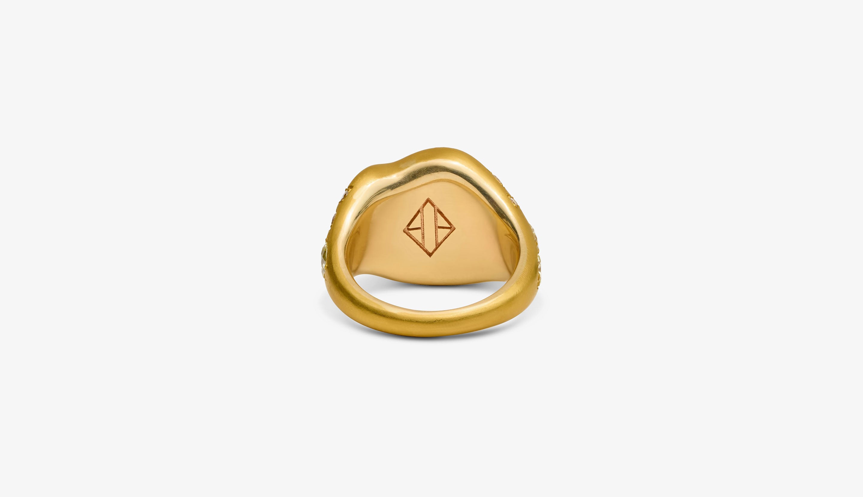 Blonde woman with slicked-back hair wearing a black strapless top and a choker necklace with a large light blue gemstone.