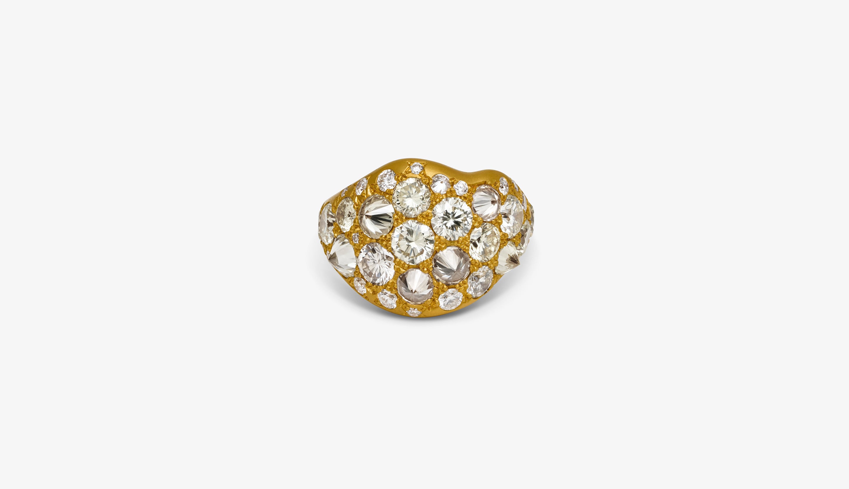 Blonde woman with slicked-back hair wearing a black strapless top and a choker necklace with a large light blue gemstone.