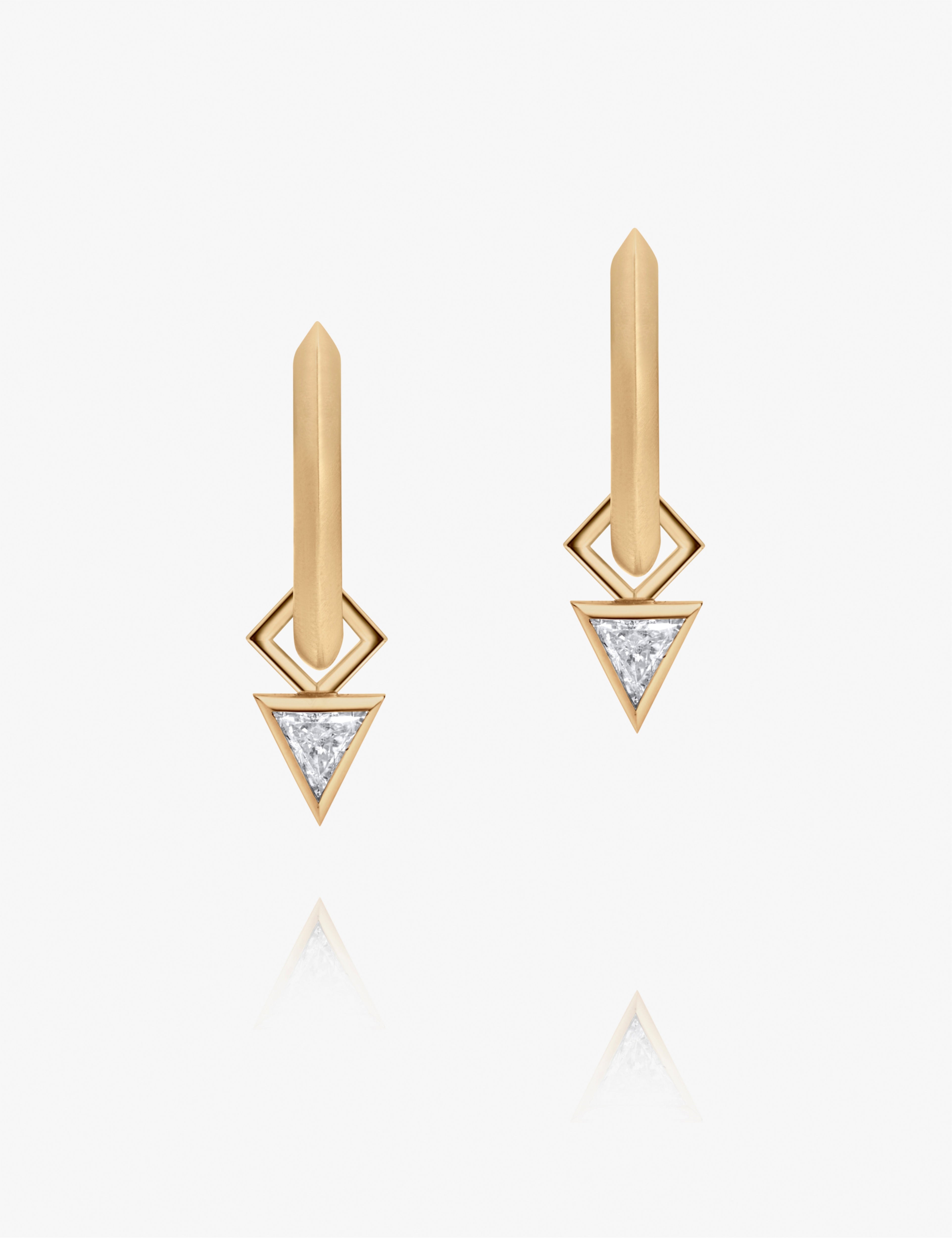 Yellow gold earrings featuring triangle-cut diamonds in sleek geometric drop design on white background.