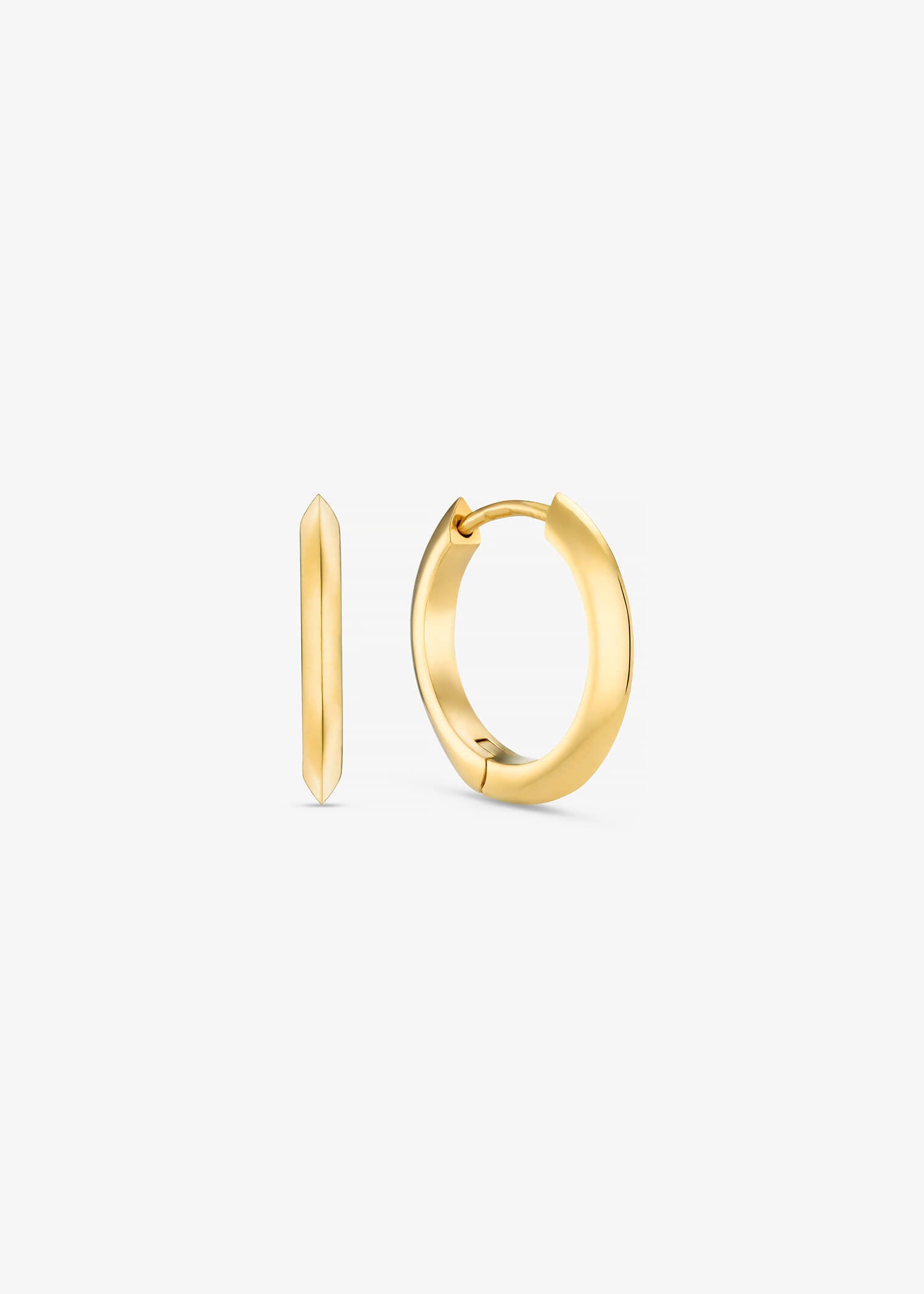Brushed 18k yellow gold oval hoop earrings on textured grey background.