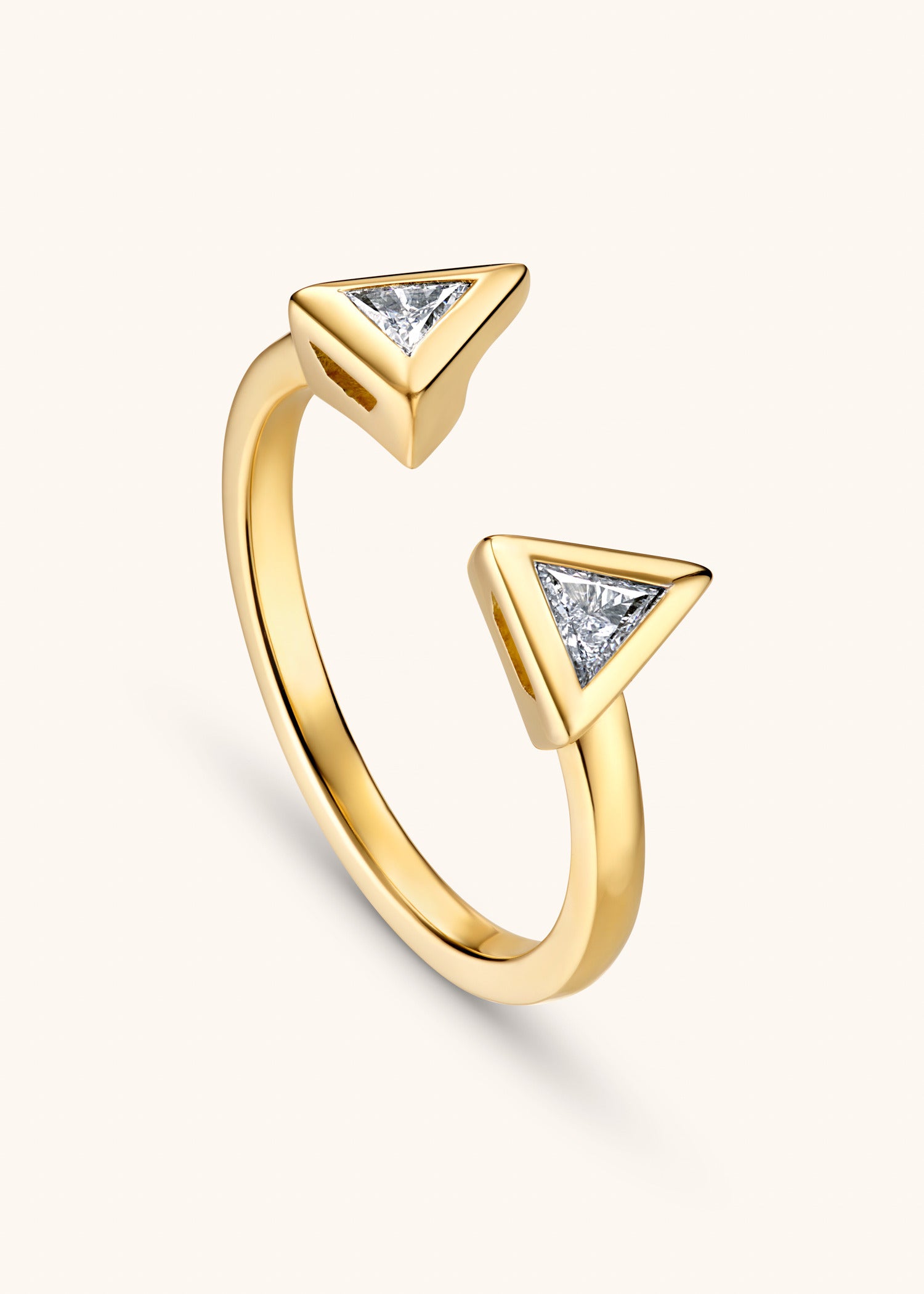 Yellow gold open ring with two triangular diamond settings facing each other.