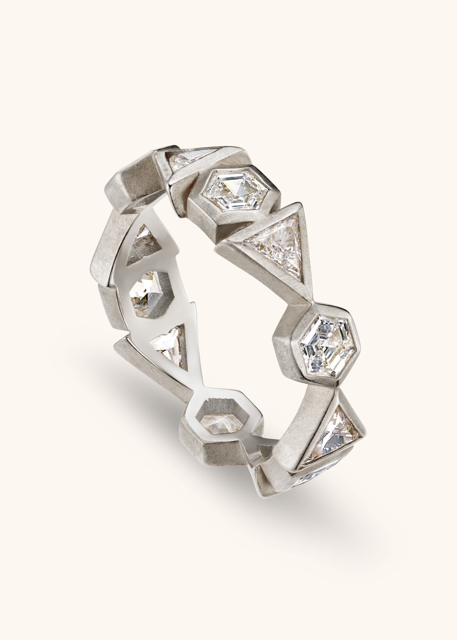 Gold ring with diamond accents on a light gray background.