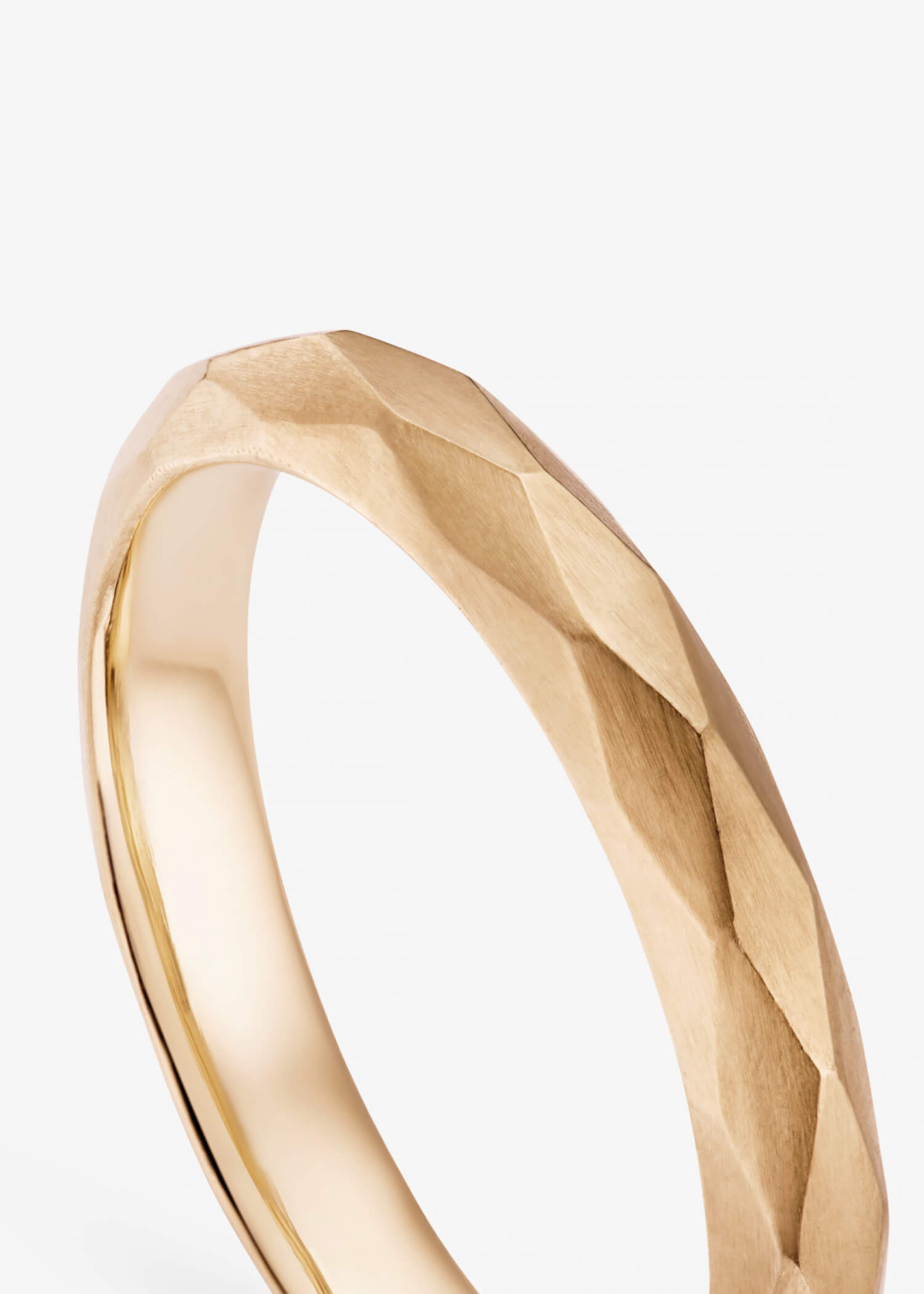 18k rose gold bangle bracelet detail showcasing a sleek minimalist fine jewelry design.