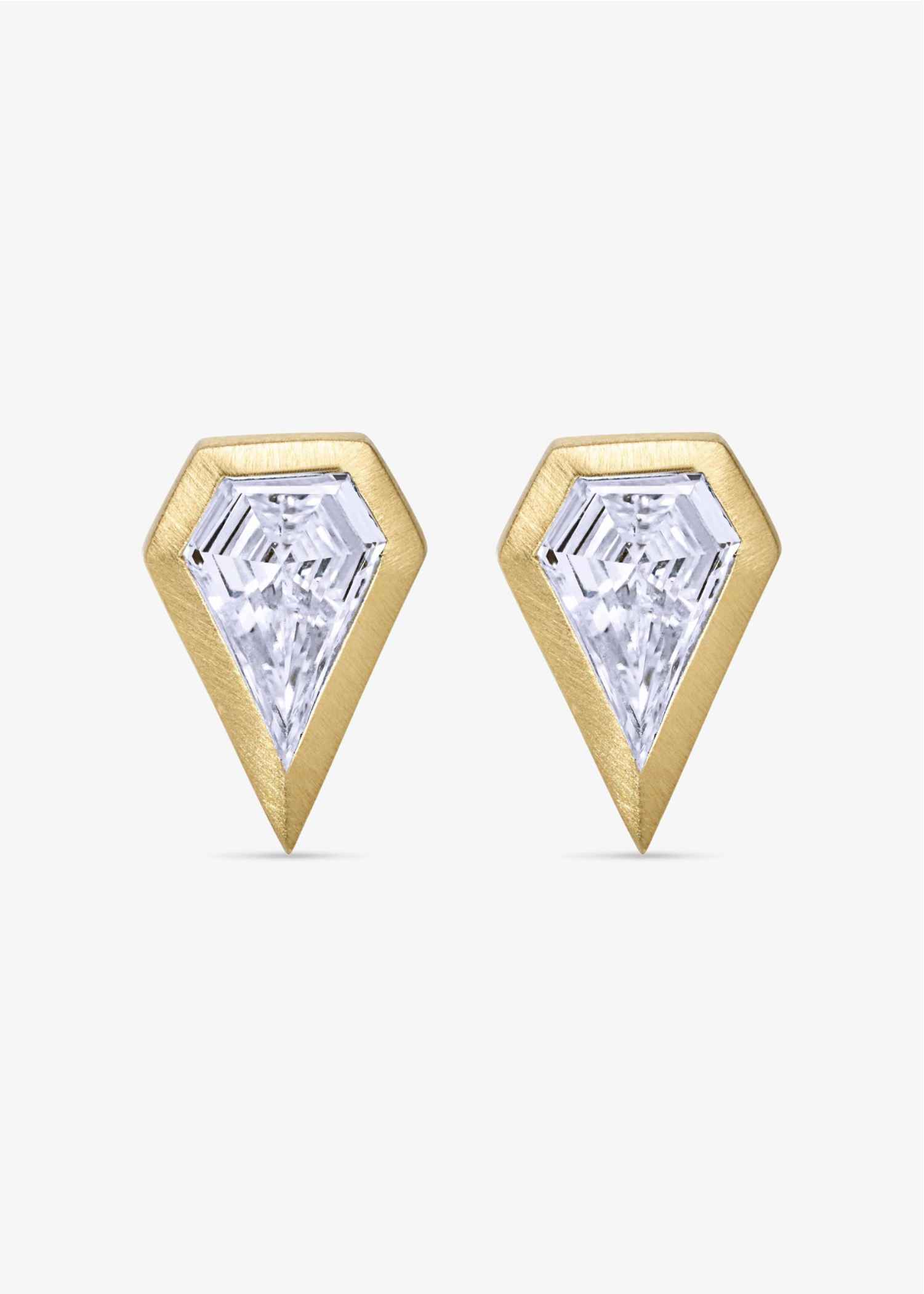Gold earrings with clear gemstones on a white background.